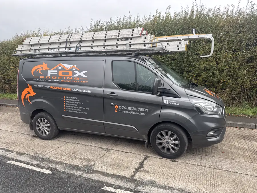 The Fox Roofing van with ladders on the roof rack and the services listed on the side
