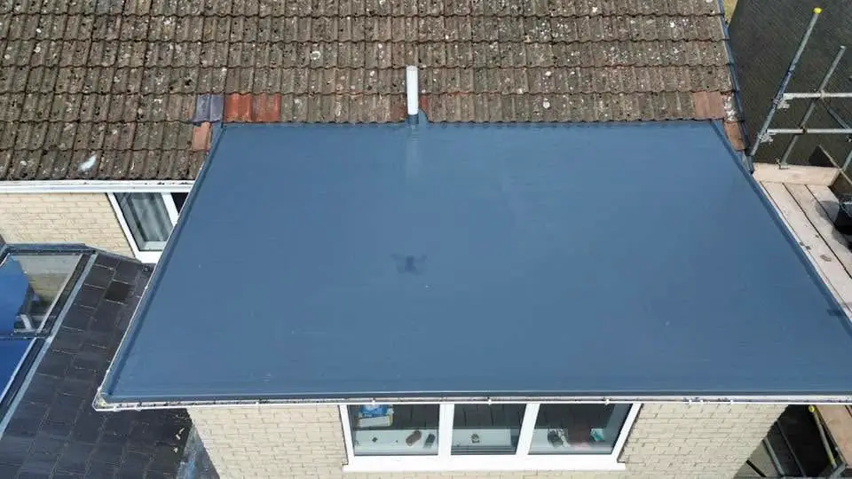 After: the flat roof re-covered in a smooth grey membrane, seen from above